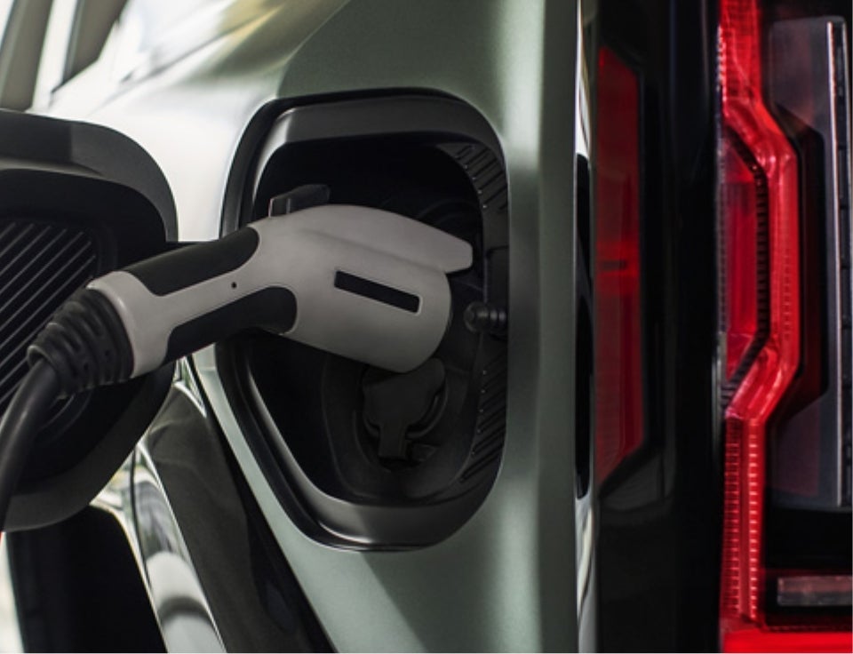 Close up of charging port with charger plugged in on a GMC Hummer EV SUV - SVG Springfield GMC in SPRINGFIELD OH