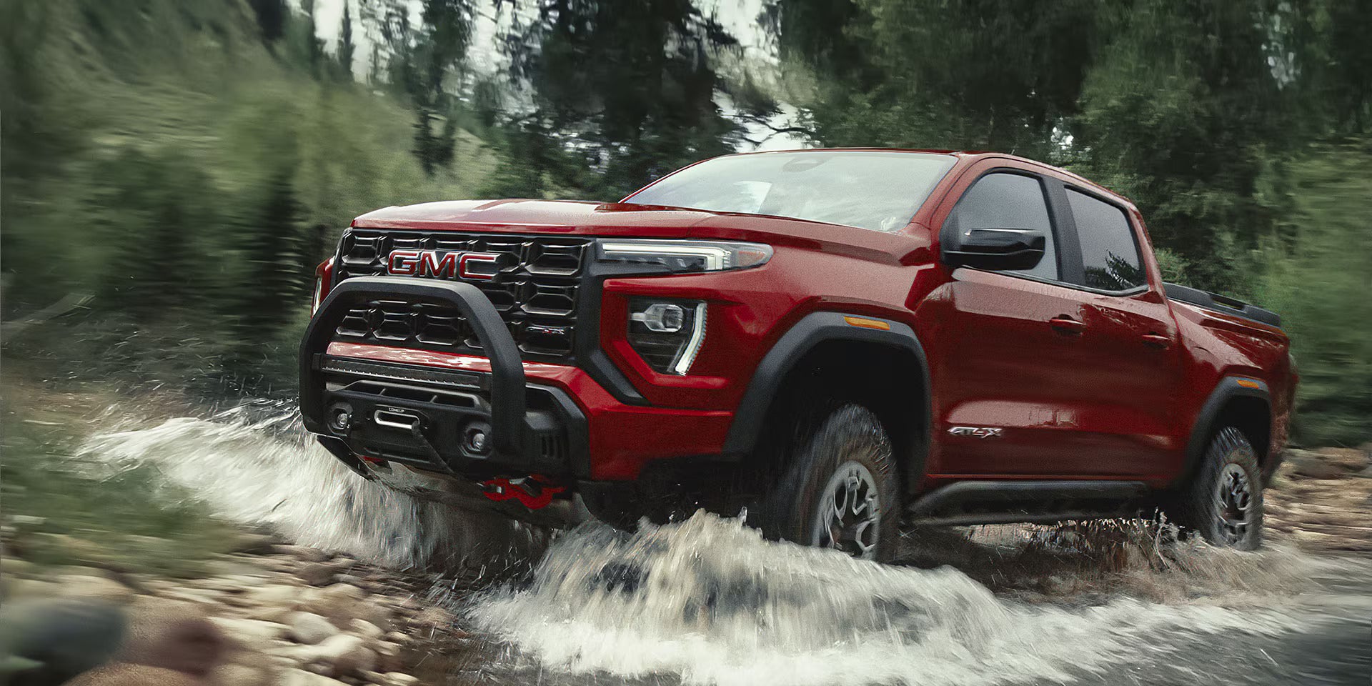 2026 GMC Canyon driving in a creek
